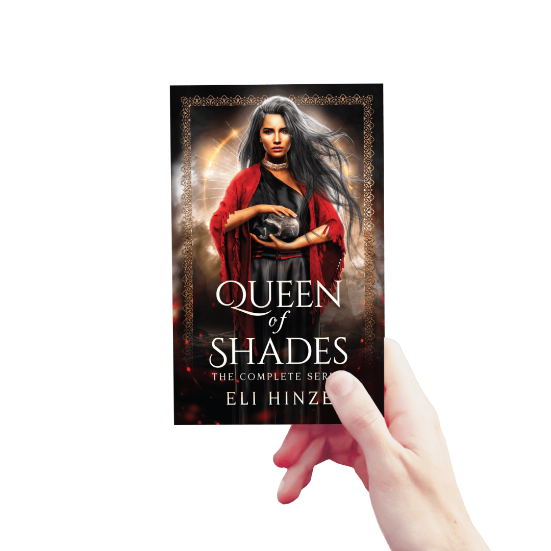 A hand holding up a paperback of the complete ancient fantasy book series Queen of Shades by Eli Hinze