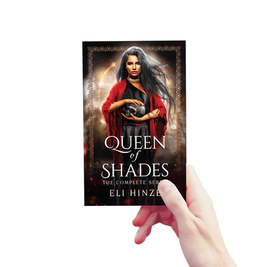 A hand holding up a paperback of the complete ancient fantasy book series Queen of Shades by Eli Hinze